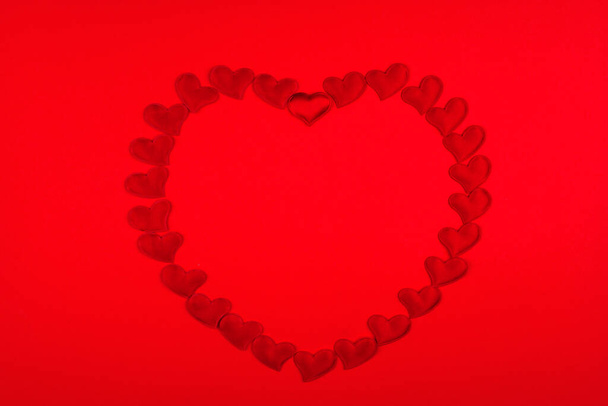 Red hearts in the shape of a heart background for Valentine's Day. - Фото, зображення