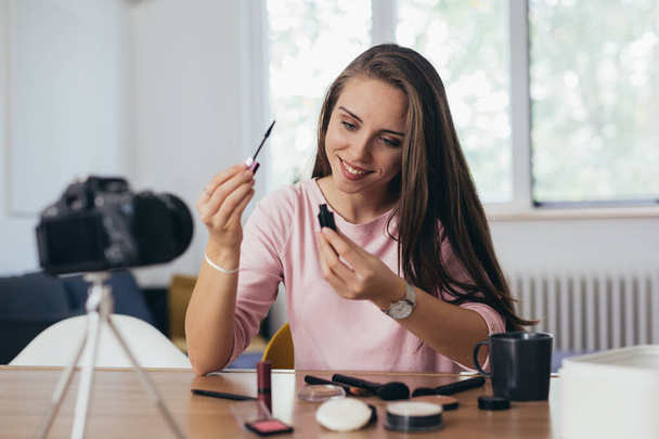 young woman making video blog about cosmetic products - Fotoğraf, Görsel
