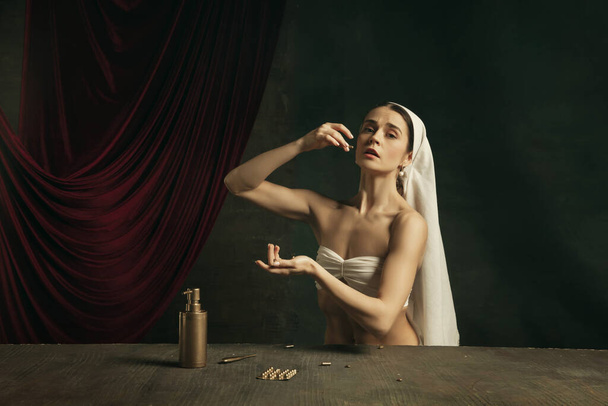Modern remake of classical artwork with coronavirus theme - young medieval woman on dark background - Фото, зображення
