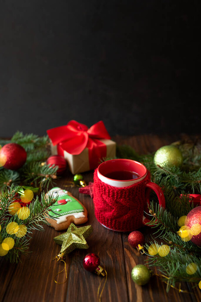 Hot Christmas tea with gingerbread cookie on wooden table. Top view. New Year and Christmas celebration concept. Top view - 写真・画像
