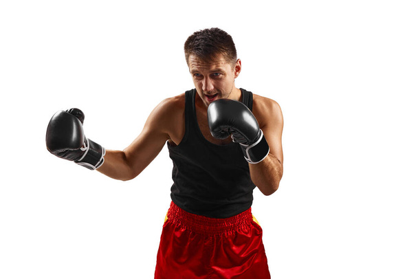 sporty man in black boxing gloves punching - Foto, immagini