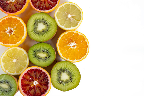 conjunto de frutas con vitamina c, kiwi, lelón, naranja roja, naranja amarilla en un corte aislado en blanco - Foto, Imagen