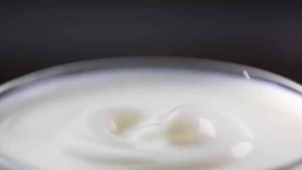 Milk drop falls into the filled cup. Slow motion. - Footage, Video