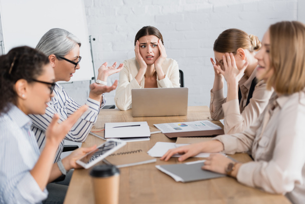 worried interracial businesswomen discussing problem during meeting in office   - Fotoğraf, Görsel