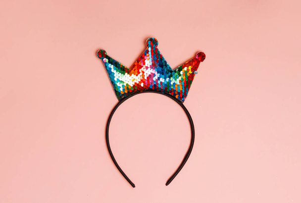 Crown headband lying pink background. Birthday, or coronavirus, covid 19 concept. - Photo, Image
