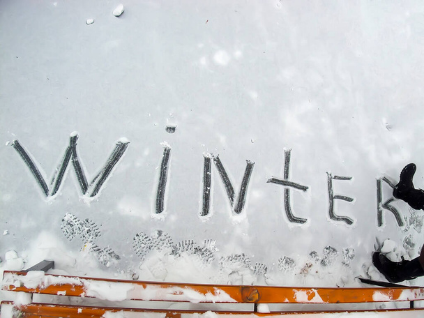 das Wort Wintermädchen schrieb mit dem Stiefel in den Schnee - Foto, Bild