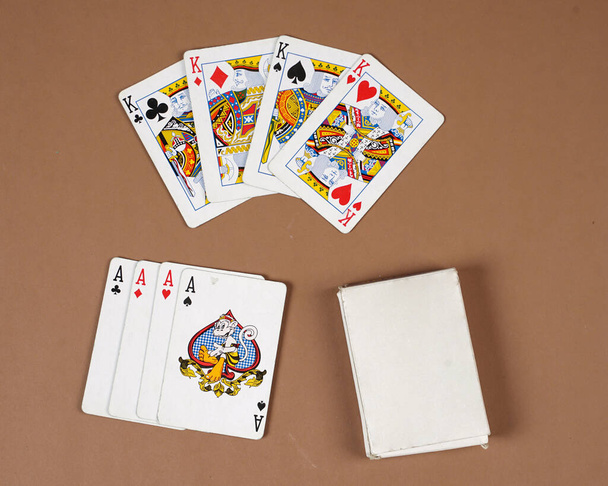Poker playing cards. Poker set with isolated cards on brown background. Poker playing cards, full deck. Classic design of playing cards poker Games. - Photo, Image