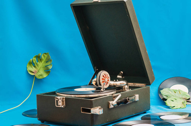 Vintage vinyl record player with monsters leaf. Vinyl records on - Photo, Image