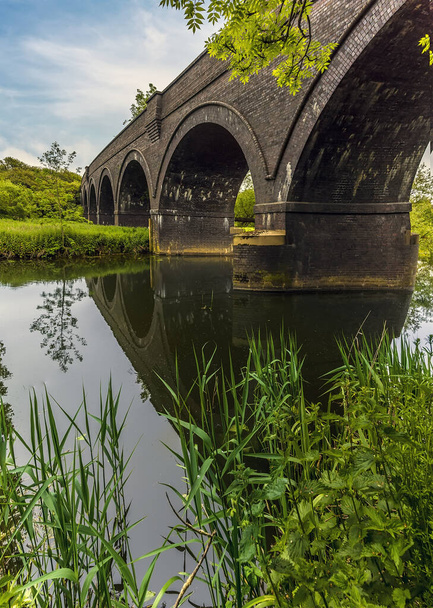 A panorama view of the abandoned viaduct across the River Nene at Thrapston, UK in springtime - Foto, imagen