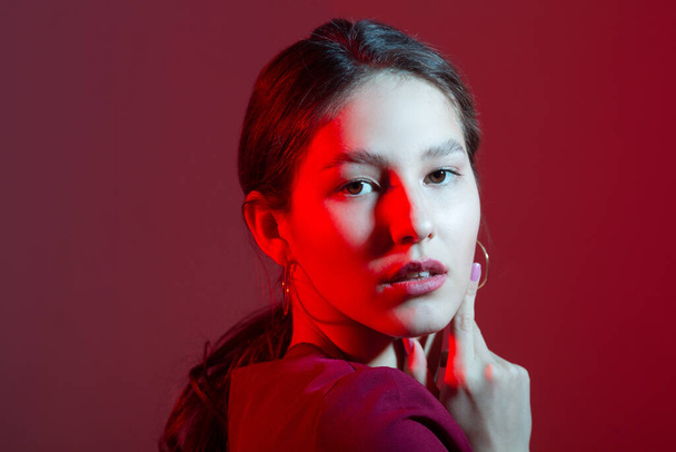 portrait of a beautiful young woman with colored lighting - Photo, image