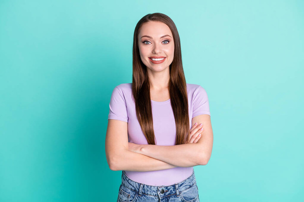 Photo portrait of pretty girl smiling with crossed hands wearing purple t-shirt isolated on bright teal color background - Foto, immagini