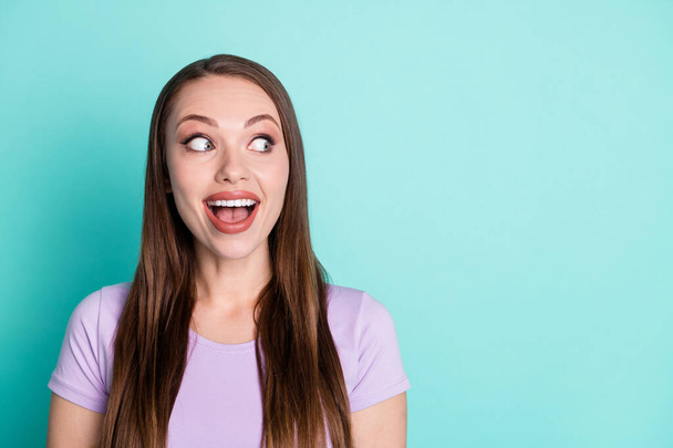 Photo portrait of amazed surprised girl with straight hair staring on blank space with opened mouth isolated on bright teal color background - Foto, Imagen