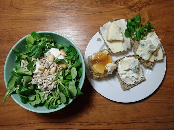 a fresh portion of bread with cheese and with salad  - Photo, Image