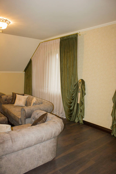 curtains and tulle in the interior with a non-standard window - Photo, Image