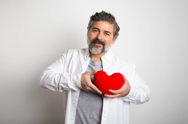 Wereld hart dag witte achtergrond Man met een rood hart. Gelukkige Valentijnsdag - Foto, afbeelding