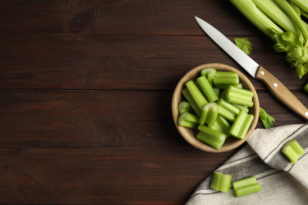 Fresh ripe green celery on wooden table, flat lay. Space for text - Фото, изображение