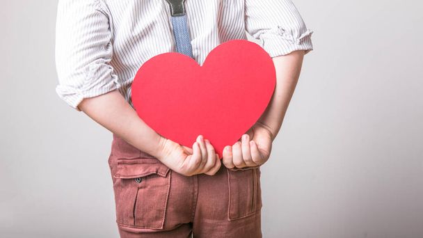 Boy holding a red heart  - Φωτογραφία, εικόνα