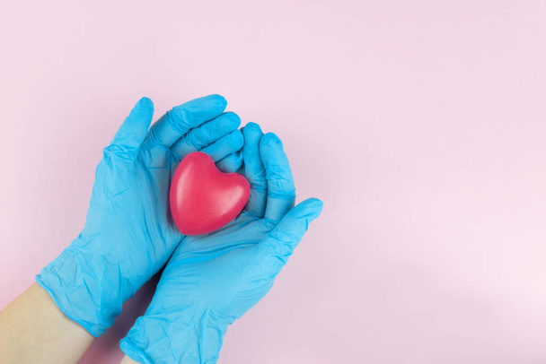 Cropped view of doctor holding red heart in hands, health insurance, donation, charity , saving life, thank you - 写真・画像