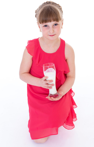 Cute little girl is holding big glass of milk - Φωτογραφία, εικόνα