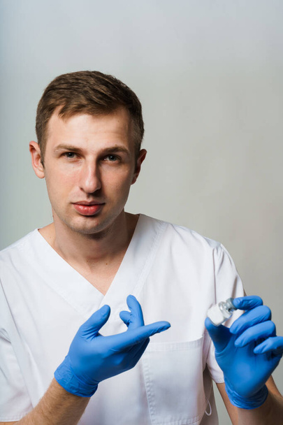 Coronavirus vaccine. Doctor holding covid-19 vaccine in his hands - 写真・画像