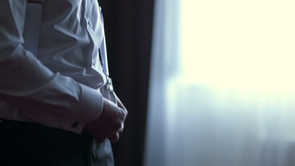 Mann passt Hosenträger an, trägt Kleidung - Filmmaterial, Video