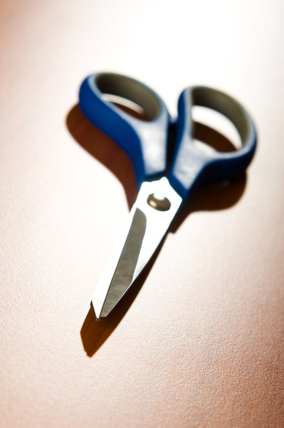 Office scissors against wooden background - Fotoğraf, Görsel
