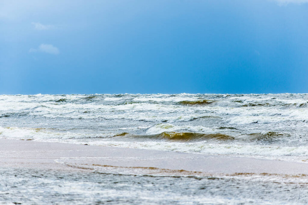 Stormy weather. Cloudy blue sky and waves, Baltic sea, Latvia - Foto, immagini