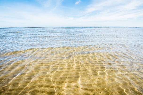 A view of the sandy shore of the Baltic sea on a sunny day. Crystal clear water. Kemeri, Latvia - Photo, Image