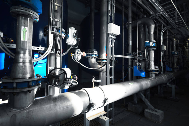 Large industrial water treatment and boiler room. Shiny steel metal pipes, pumps, valves. Industry, technology, special equipment, biotechnology, chemistry, ecology, heating, workplace safety - Photo, Image