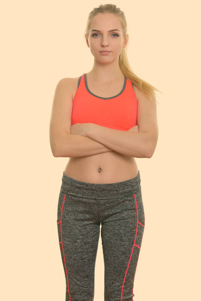 Studio shot of young beautiful teenage girl standing with arms crossed ready for gym - Photo, image