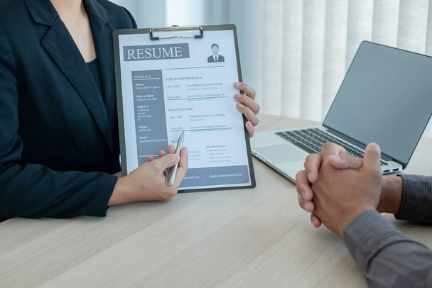 Business people hold a resume and talk to job applicants for job interviews about careers and Her personal history in the company. Recruitment concepts. - Photo, Image
