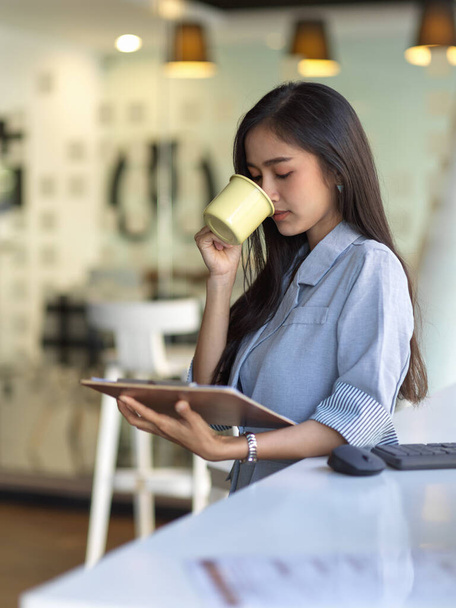 Portrét podnikatelky si udělat přestávku na kávu při práci s tabletem v kanceláři - Fotografie, Obrázek