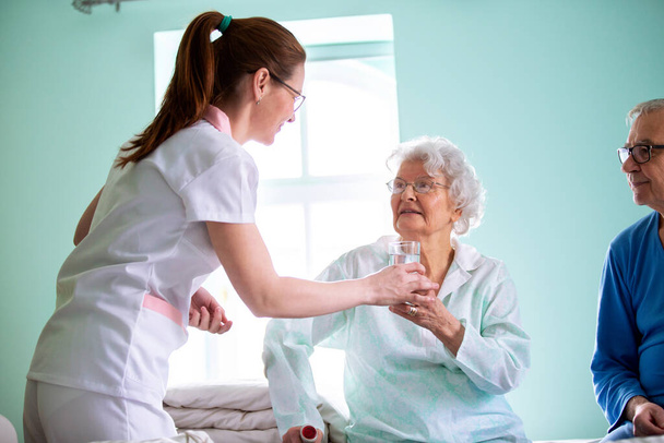 Nursing home concept, taking care of elder people, providing a broad range of long term services to elderly, helping senior population - Foto, afbeelding