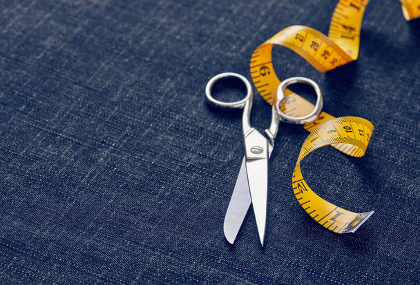 Scissors and measuring tape on jeans - Fotoğraf, Görsel