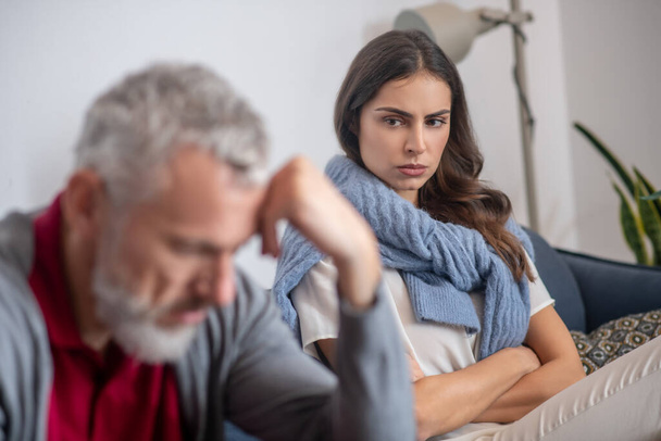 Woman looking angrily on her grey-haired husband - Photo, Image