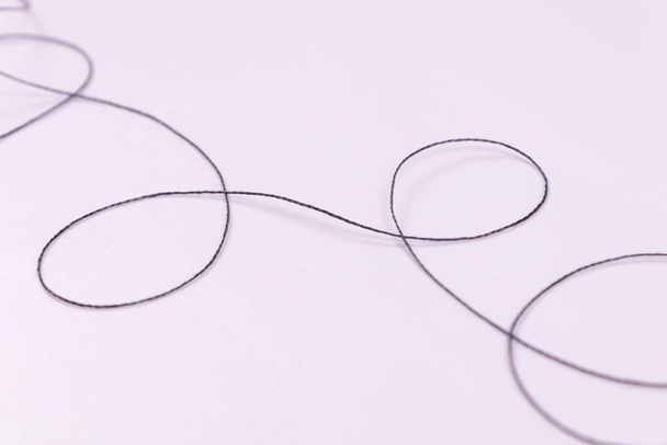 one black thread is laid in turns - Photo, Image