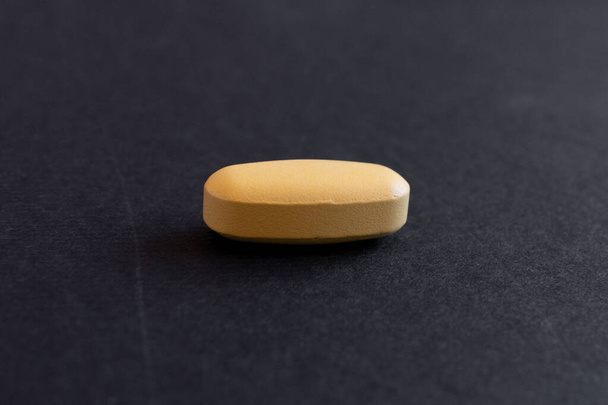 A closeup of a medical tablet on a black background - Zdjęcie, obraz