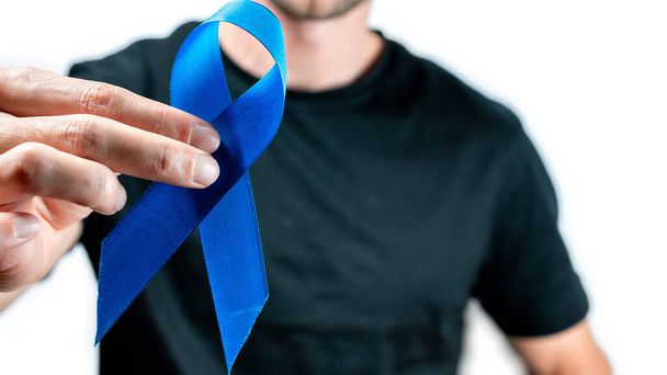 Cancer people. Hipster men in dark shirt with blue ribbon in hands isolated on white background. Awareness prostate cancer of men health in November. Man Healthcare and World cancer day concept - Φωτογραφία, εικόνα
