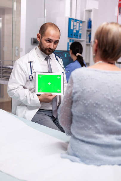 Artsen met groene tablet in privé kliniek - Foto, afbeelding