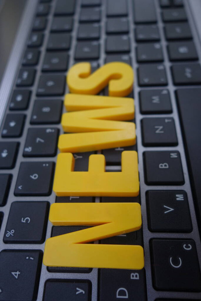 News concept. Yellow letters on a keyboard - Photo, Image