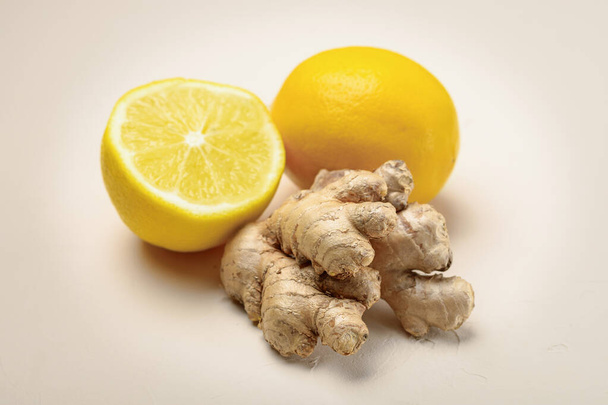 Close-up of ginger and lemon on a light beige background. - Photo, image