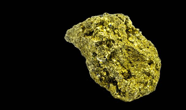 An isolated shot of a lump of shiny cat gold pyrite which looks similar to the real gold on a black background - 写真・画像