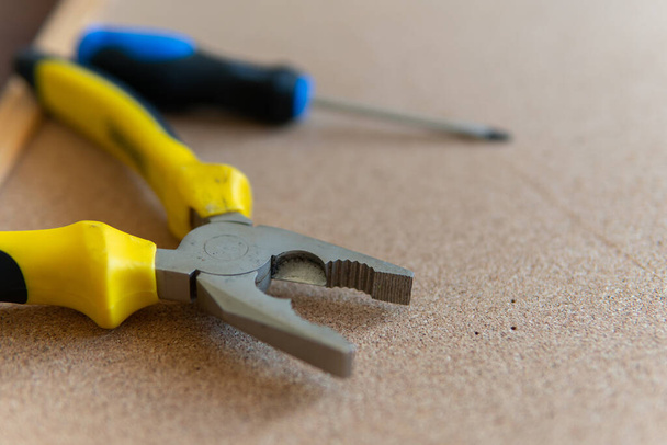 A selective focus closeup of pliers and a screwdriver - 写真・画像