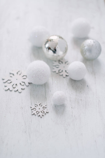 A selective focus shot of Christmas balls and cute wooden snowflakes - Photo, image