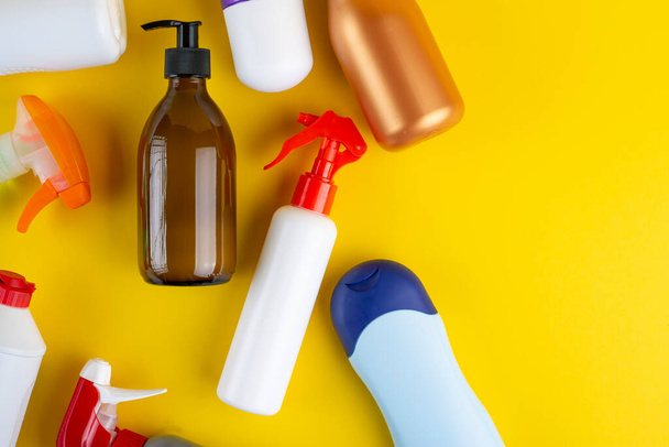 Set of cosmetic containers on a yellow background. Top view. Beauty and personal care concept - Fotó, kép