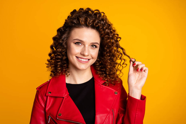 Close-up portrait of her she nice attractive lovely cheery wavy-haired girl touching curls isolated on bright vivid shine yellow color background - Valokuva, kuva