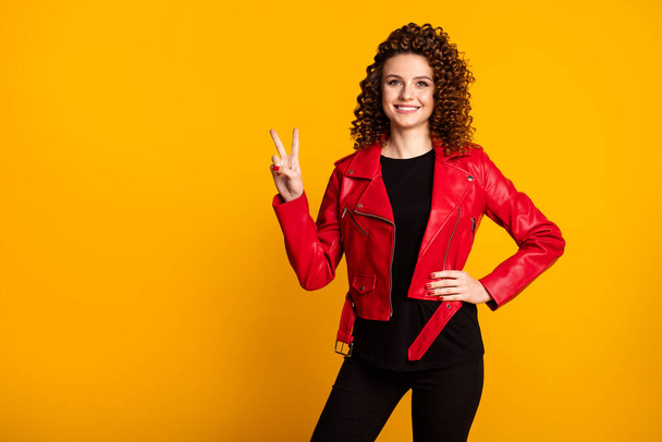 Portrait of her she nice attractive cheerful wavy-haired girl showing v-sign isolated over bright vivid yellow color background - Foto, afbeelding