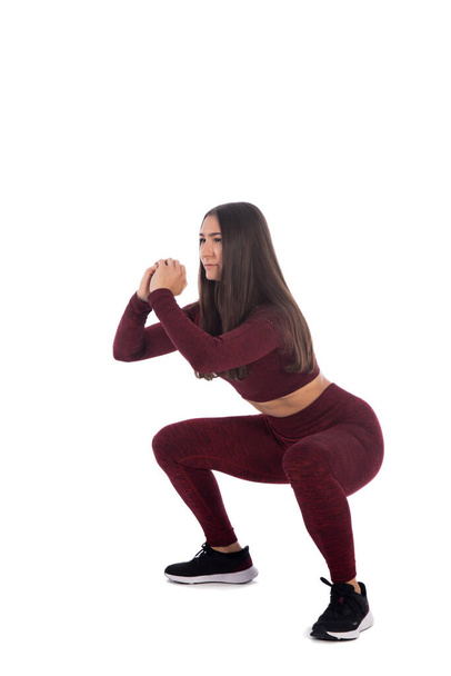Retrato de larga duración de una hermosa joven haciendo ejercicio de estiramiento aislado, mujer haciendo ejercicio físico, aislado - Foto, imagen