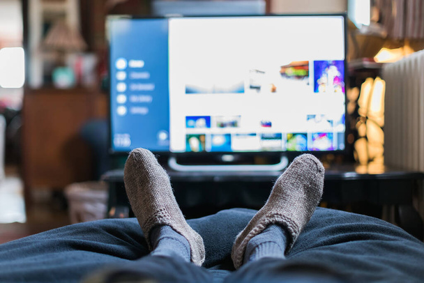 watching smart tv lying down during pandemic lockdown - Photo, image