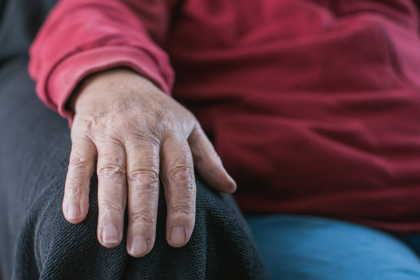 old person's hand resting on armchair - Φωτογραφία, εικόνα
